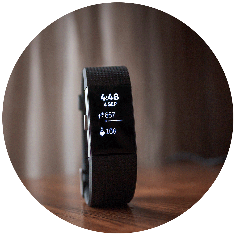 Fitbit Charge 2 propped up on a wooden table