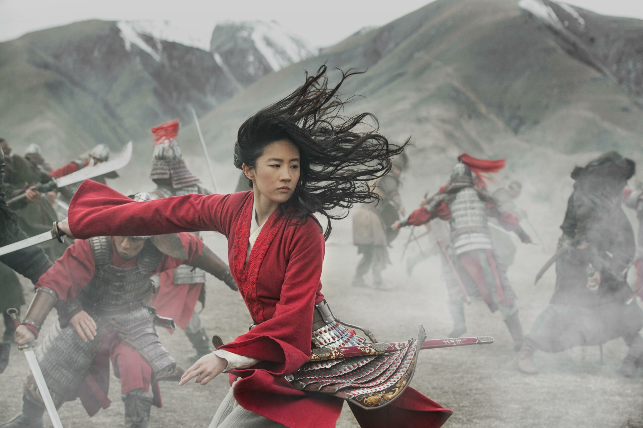 Mulan, a young maiden, in combat -- with her hair open and flowing in the wind to signify her power and ability