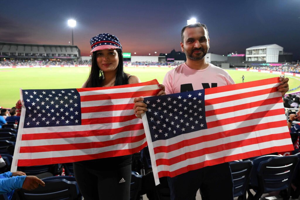 Fans holding USA flags at opening match of T20 World Cup 2024 in Dallas, Texas