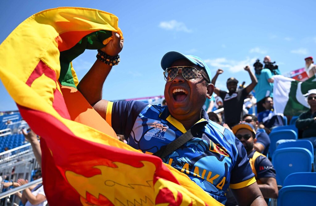 Sri Lankan fan with flag cheers his team on at Nassau County Cricket Stadium during the 2024 T20 World Cup
